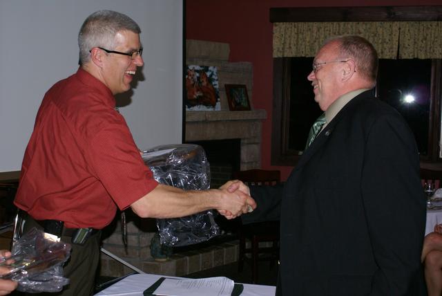 Dive Captain Ken Mclaughlin is awarded plaque for 2nd most fire calls 2011-2012 from Chief Keough